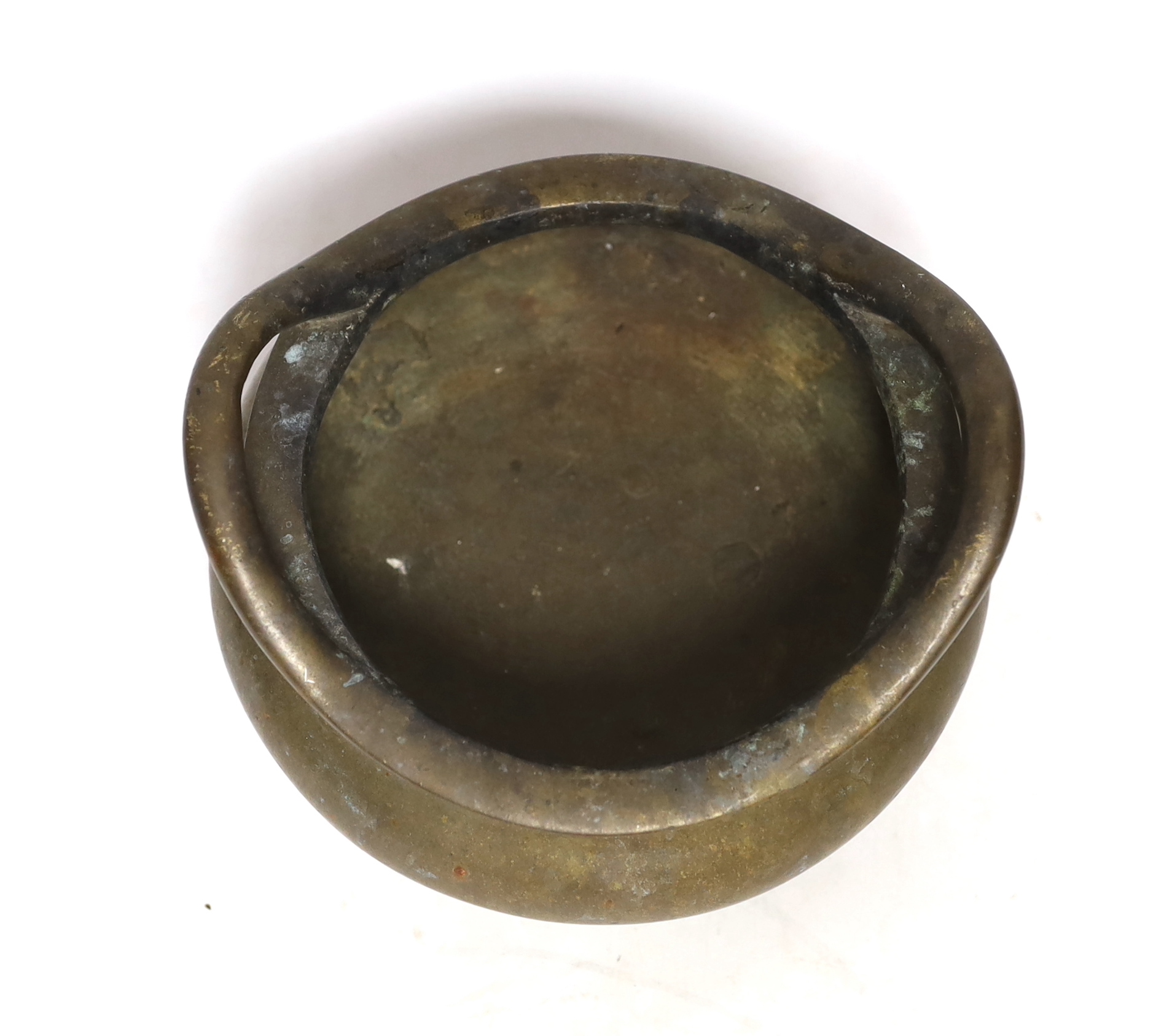 A Chinese bronze censer with twin handles and tripod feet, 18cm wide